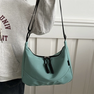 Waterproof mint green nylon tote bag for women with adjustable strap and spacious interior