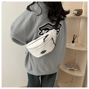White minimalist canvas fanny pack with black FANYISSA logo and adjustable shoulder strap
