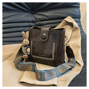 Retro brown bucket bag with gold rivets, boho strap and rabbit plush pendant detail