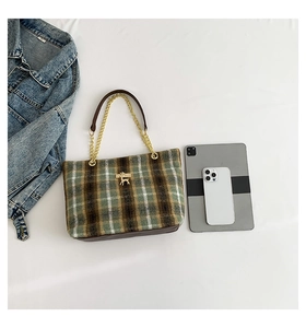 Detail view showing medium size wool plaid tote bag capacity with tablet and phone