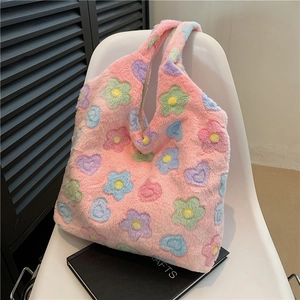 Pink plush tote bag with colorful flower patterns on a white chair for winter style