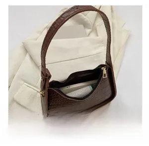 Top view of dark brown croc-pattern hobo bag showing interior capacity and zipper detail