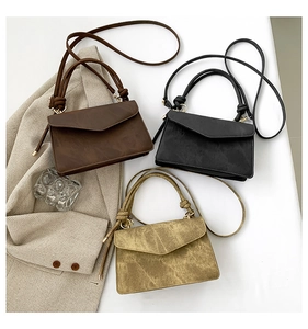 Three retro envelope-style crossbody bags in brown, black, and olive green matte faux leather