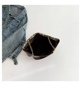 Detail view of large capacity brown tote bag with gold chain and plaid interior