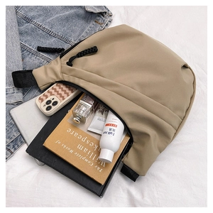 Detailed view of spacious interior of khaki nylon dumpling bag showing high capacity