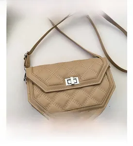 Detail view of beige quilted faux leather bag with silver metal twist-lock and stitching