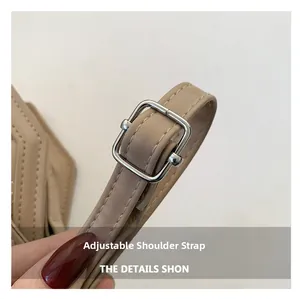 Detail show of adjustable khaki shoulder strap with silver buckle on the rhombus square bag