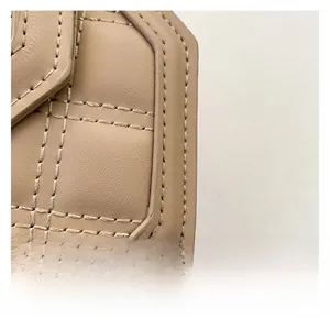 Detailed macro view of khaki quilted leather texture and premium stitching on shoulder bag