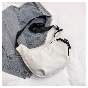 Close-up of white nylon crescent bag featuring black adjustable strap and cord zipper puller
