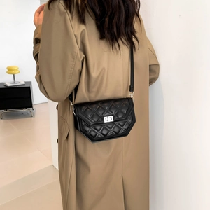 Chic black quilted crossbody bag with silver hardware and hexagonal geometric base