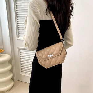Quilted crossbody bag in beige PU leather featuring a silver metal twist lock buckle
