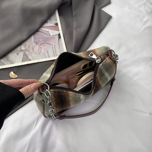 Green and brown plaid faux fur baguette bag with chain strap and leather handle