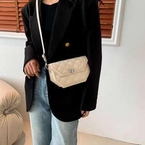 Quilted off-white crossbody bag featuring a silver twist lock and slim shoulder strap