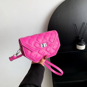 Detail of fuchsia quilted crossbody bag with white stitching and silver twist lock