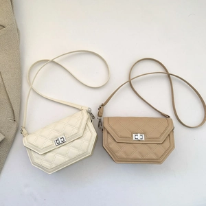 Close-up of quilted crossbody bags with silver metal turn-lock and irregular flap design