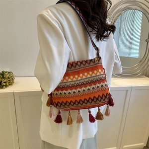 Ethnic style woven crossbody bag with colorful tassels and geometric wide shoulder strap