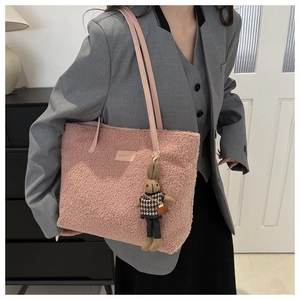 Pink plush tote bag with a cute bunny charm and metal logo detail for women