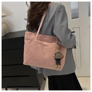 Close-up of pink faux shearling tote with Fashion patch and cute rabbit charm