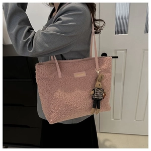 Close-up of pink fuzzy tote bag featuring soft fleece texture and cute bunny charm