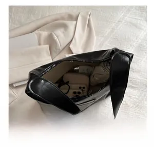Interior view showing the large storage capacity of a black retro tote bag with daily items