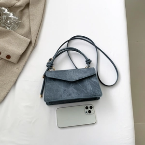 Trendy blue distressed faux leather mini crossbody bag with knot handle and long strap