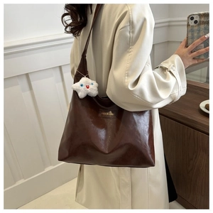 Retro dark brown leather tote bag with white cloud plush charm and square patch detail