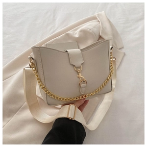 Off-white trapezoid shoulder bag with gold chunky chain and wide fabric strap