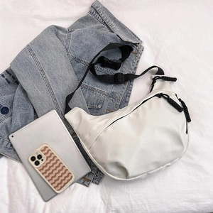 Minimalist white nylon crescent bag with adjustable black shoulder strap and zipper pull