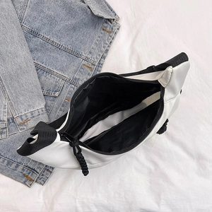 Minimalist black and white nylon crossbody bag with spacious interior compartment and zip