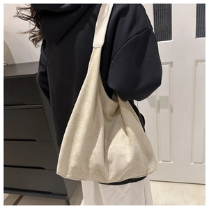 Close-up of off-white faux suede Hobo shoulder bag showing fine matte texture and soft material