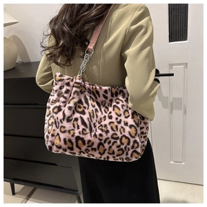 Detail view of pink leopard print plush tote with silver metal chain and leather strap