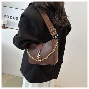 Detail of dark brown hobo bag with gold chain accent and adjustable canvas strap