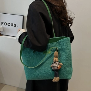 Fuzzy emerald green plush tote bag with long shoulder straps and cute rabbit charm detail