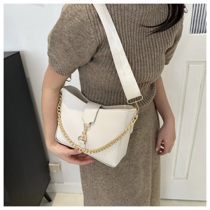Detail of off-white leather bag featuring gold chain and wide woven canvas strap
