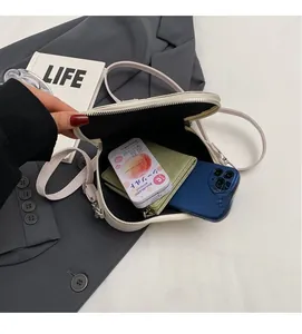Detailed interior view of a white heart-shaped crossbody bag showing storage capacity