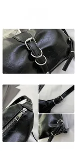 Detailed view of black vintage textured leather with silver metal hardware and zipper