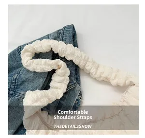 Detail of comfortable wide shoulder strap on cream bubble textured tote bag
