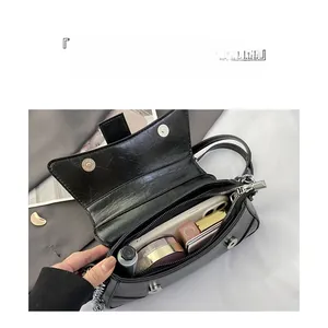 Interior view showing the large storage capacity of this black pleated crossbody bag