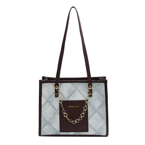Grand sac cabas en denim matelassé bleu avec cuir marron et chaîne florale dorée