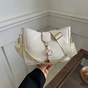 Minimalist cream white bucket bag with gold chain strap and stylish wide woven shoulder strap