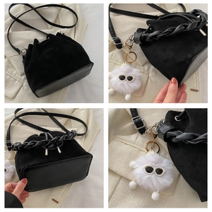 Detail shots of black suede bucket bag featuring woven handle and plush charm detail