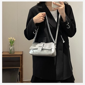 Silver metallic shoulder bag with chunky chain detail and vintage buckle hardware