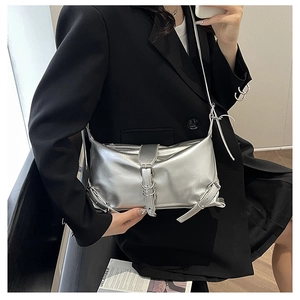 Silver metallic shoulder bag detail showing wrinkled faux leather texture and punk metal buckle