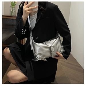 Detail shot of metallic silver shoulder bag showing adjustable strap and metal ring buckle