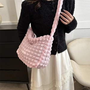 Chic pink popcorn textured crescent shoulder bag for women shown on model for daily commute