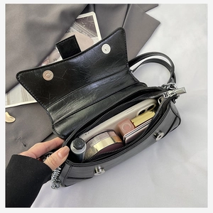 Detail view of the black saddle bag interior showing ample space for daily essentials
