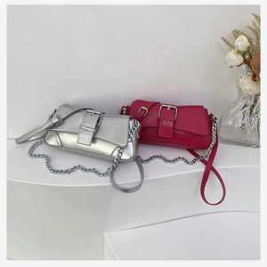 Detail of silver and rose red vintage chain bags with buckle on minimalist display
