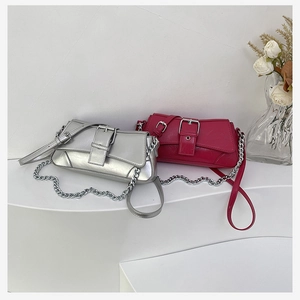 Detail of vintage textured shoulder bags with large silver buckles and chain straps