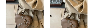 Detail of heart-shaped crossbody bag with brown faux leather texture and silver rivets
