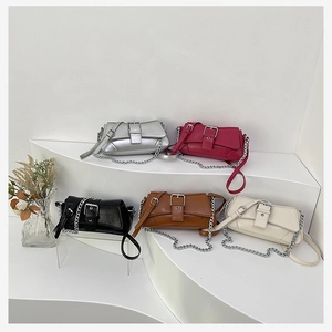 Detailed display of vintage shoulder bags in silver, pink, black, brown, and cream white